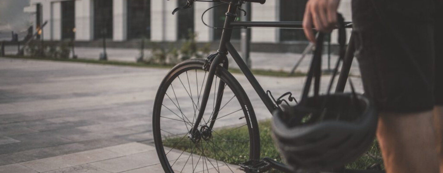 A person standing next to a bicycle